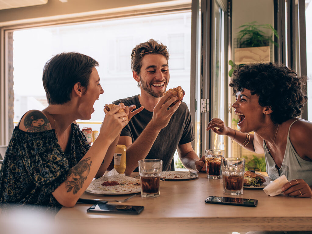 Friends laughing over a shared meal